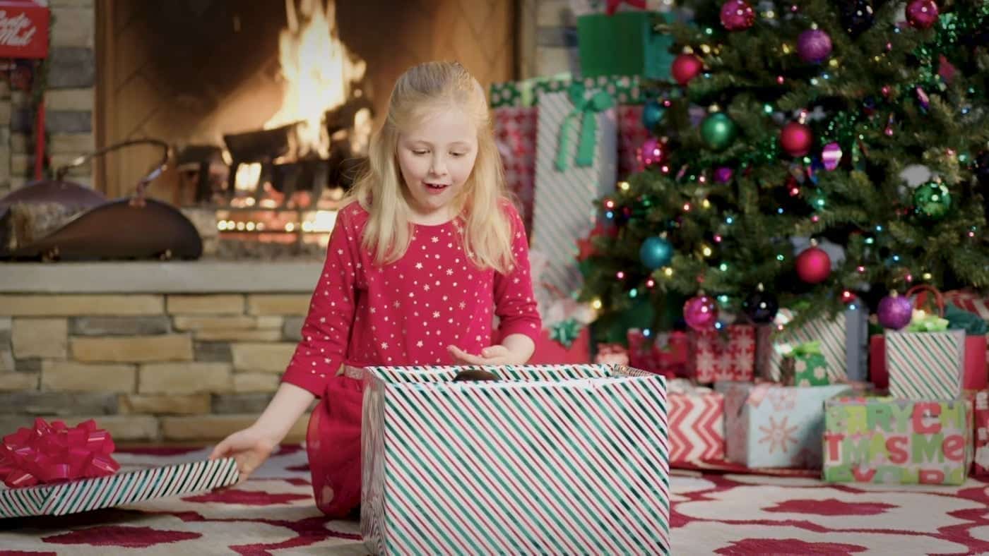 Young Girl Opening Christmas Presents Stock Photo